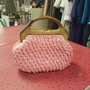 Vintage pink straw purse with wood handle.